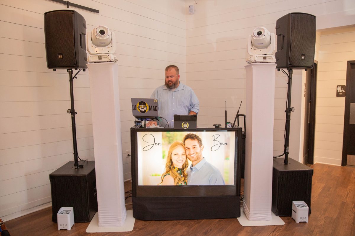 DJ Mac on the mic behind the booth
